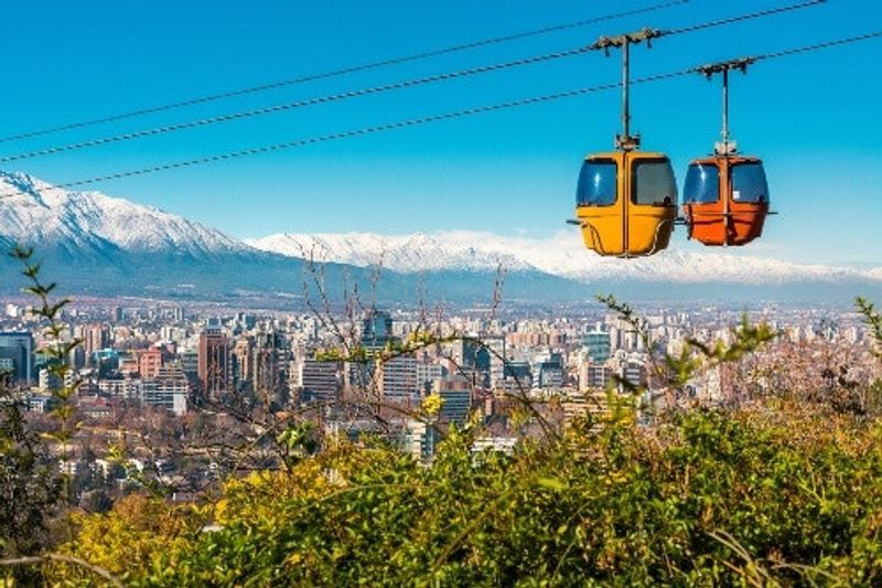 A cable car in San Cristobal Hill overlooking a panoramic view of Santiago de Chile.