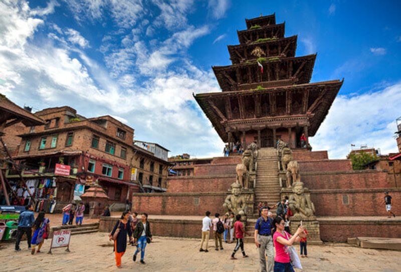 Visitors wander around the Nyatapola Temple in Nepal.