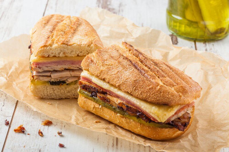 A Traditional Cuban Sandwich with Ham, pickles and cheese, said to have originated from Cuban cigar factory workers.