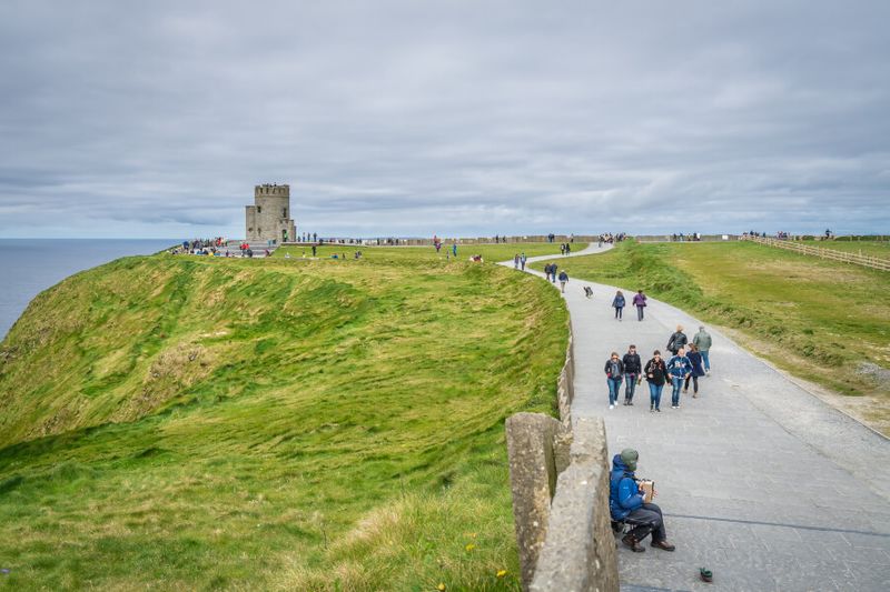 Tourists walking on a pathway leading to O'Brien Tower.