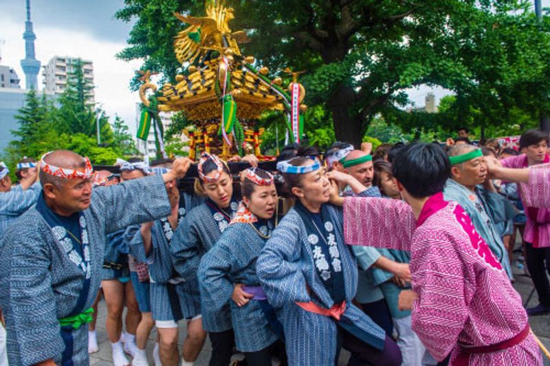 Locals in traditional clothing carrying a Mikoshi Shrine.