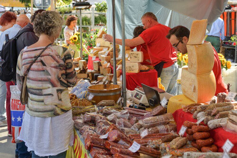 Buyers looking at local products during a traditional market in Lucerne, Switzerland.