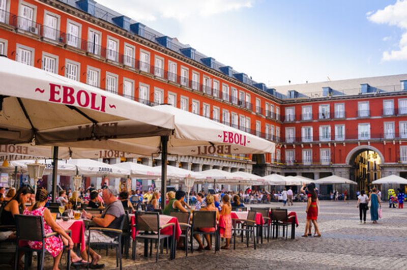 A busy outdoor restaurant in Madrid, Spain.