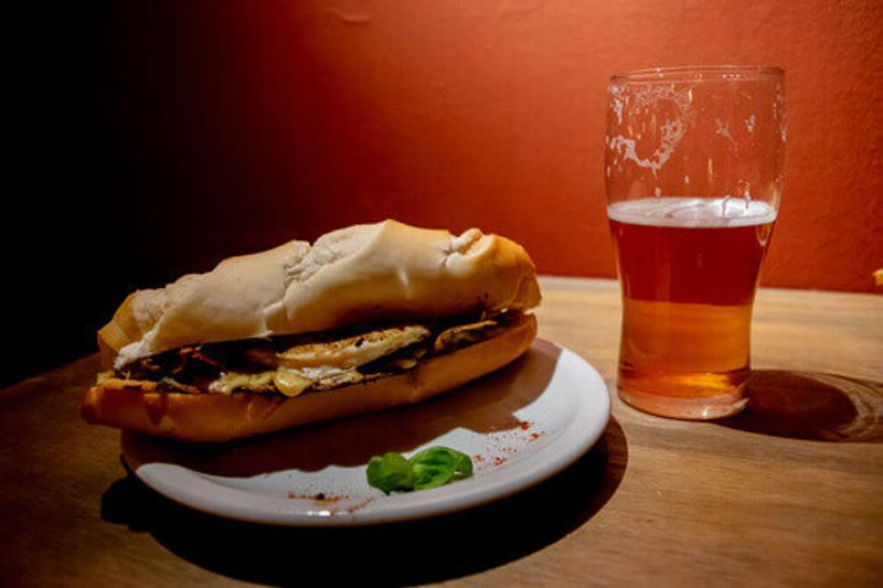 A Bondiola pork sandwich accompanied by a craft beer in Argentina.