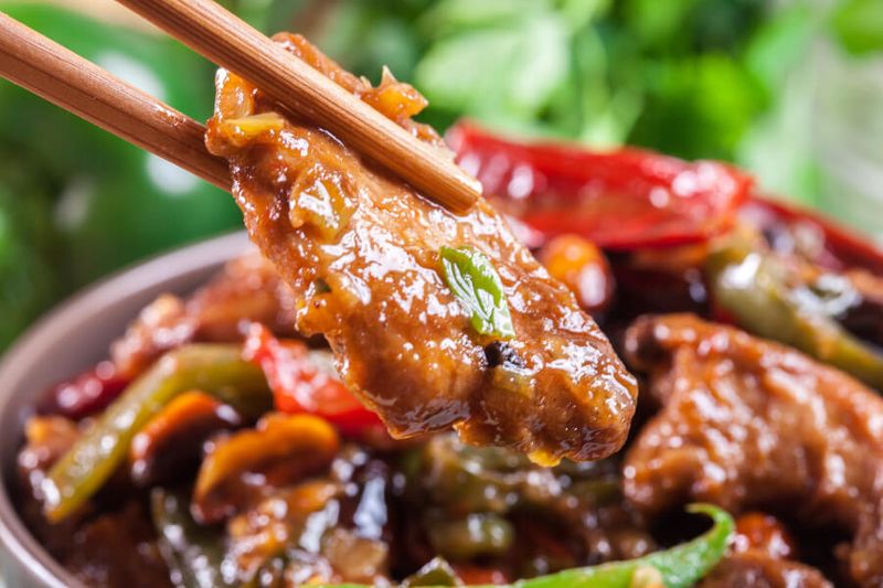 Homemade Kung Pao Chicken or Gong Bao Ji Ding eaten with chopsticks