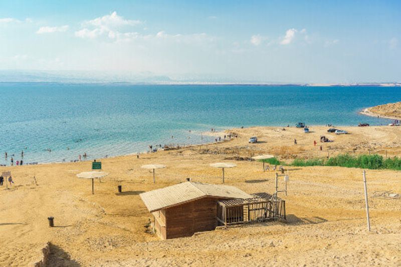People floating on water in the Dead Sea, Jordan.