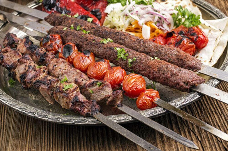 The traditional Kubideh Kebab laid out on a table.