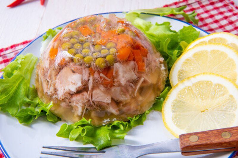 Aspic with pork knuckles and pork legs and vegetables.