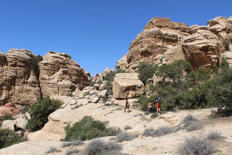 A Bedouin guide and two tourists hiking at the Dana Bioshpere Reserve.