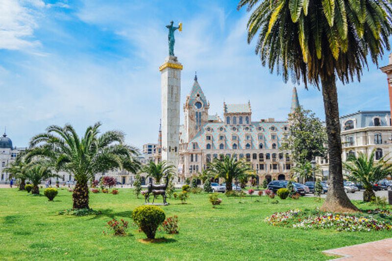 The Astronomical Clock Tower and Statue of Greek Goddess Medea in Europe Square in the city of Batumi.