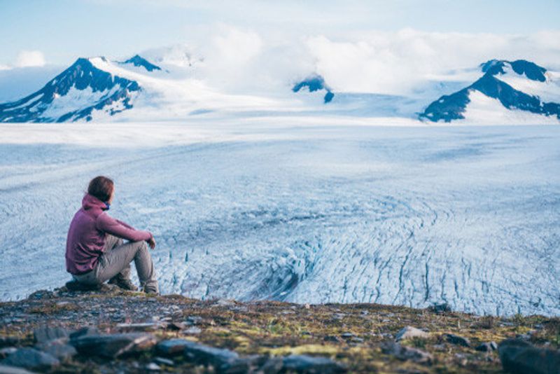 A visitor looks over the Harding icefield.