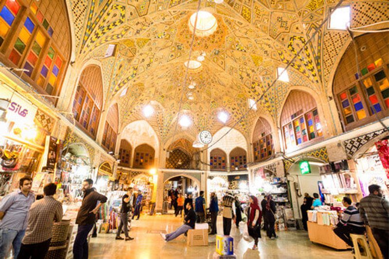 Iranian people shopping in the opulent Tehran Grand Bazaar.