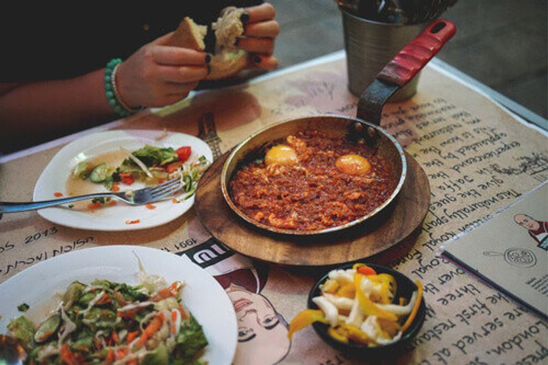 Dinner with traditional Shakshuka and salads in a local cafe.