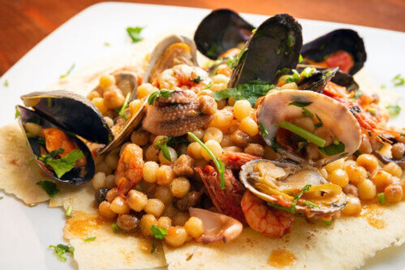 Fregola pasta with seafood, a traditional recipe from Sardinia.
