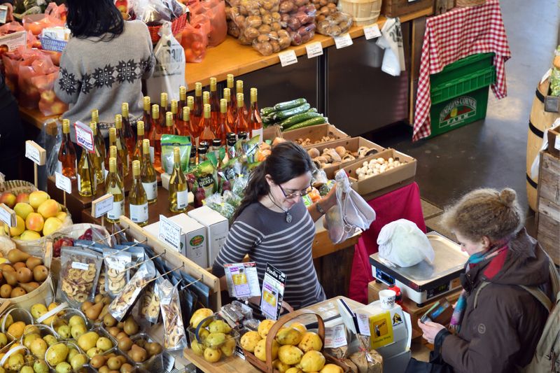 A woman shopping for fruits inside the Halifax Seaport Farmers Market