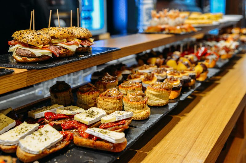 Spanish tapas called Pintxos, native to the Basque Country, served on a bar counter.