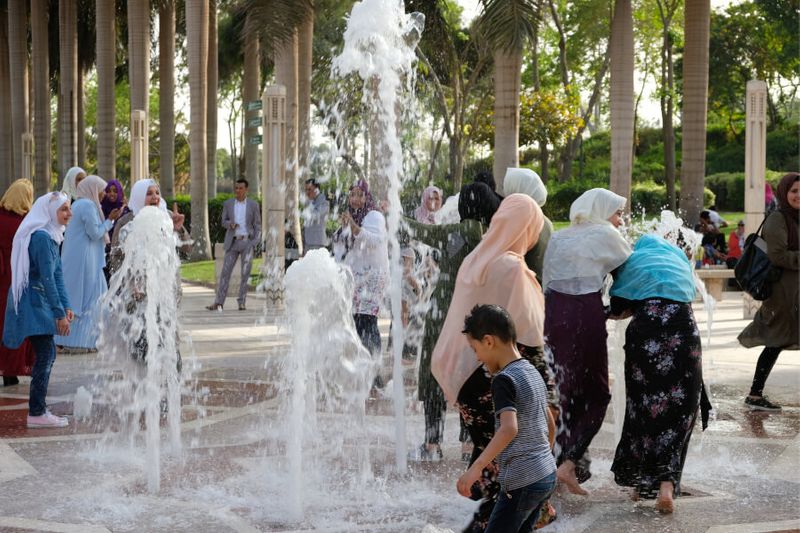 Families playing in the water fountain in Al-Azhar Park in celebration of Sham El Nessim.