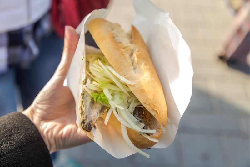 Turkish street food of fish sandwich with onions and greens called Balik Ekmek