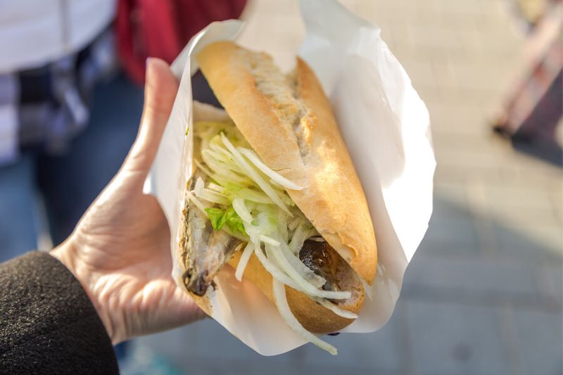 Turkish street food of fish sandwich with onions and greens called Balik Ekmek