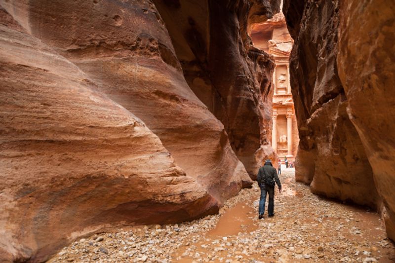 A lone tourist walking to the Treasury in Petra, Jordan.