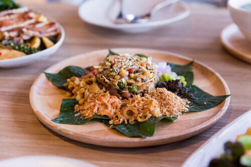 Lahpet is a Burmese Tea Leaf Salad served with deep fried garlic, peanut, white sesame, and dried shrimp.