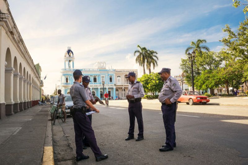 Police officers talk to one another on the streets of Havana.