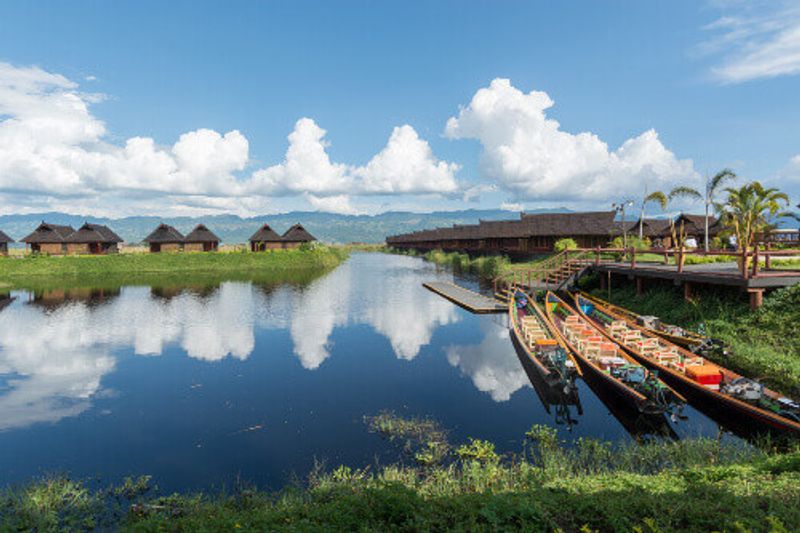 The beautiful Inle Lake with straw houses reflecting on the waters surface in Shan State.