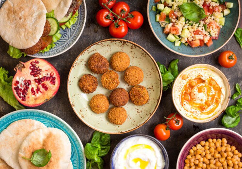 A selection of Jordanian food, including: falafel, doner kebab's, vegetarian pita, hummus, tabbouleh bulgur salad, chickpea and olive oil dip.