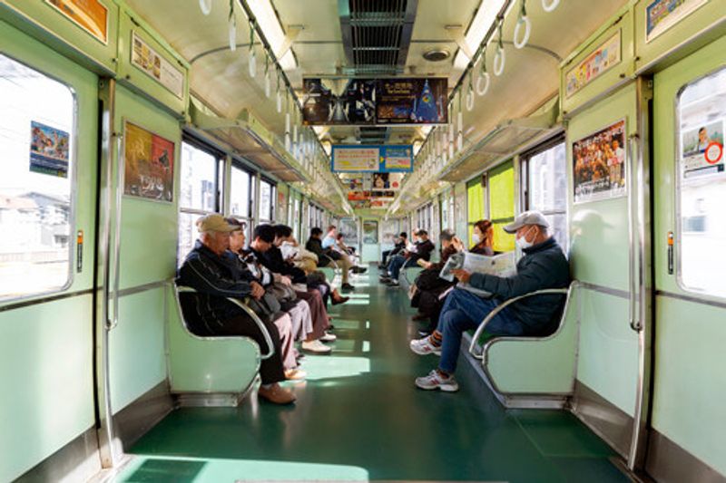 Passengers in an express train travelling through Osaka.