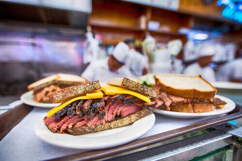 Katzs Delicatessen boasts a sandwich with reuben on rye bread with cheese.