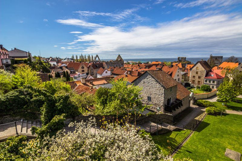 The quaint town of Visby, with small houses and trees.