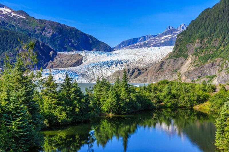 The landscape visible from the Mendenhall Glacier Viewpoint, including the lake and distant mountains.