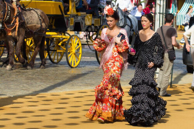 Women dressed in traditional costume at the Sevilles April Fair in Seville, Spain.