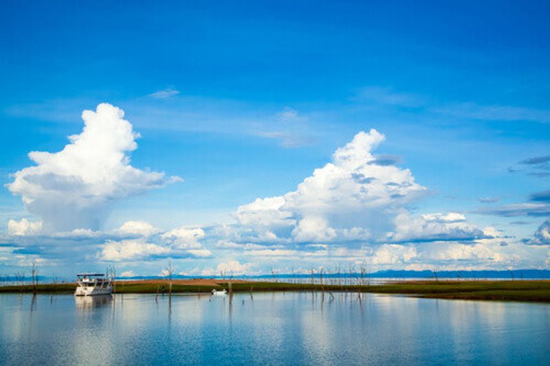 Reflections on the water with a boat in view at Lake Kariba.