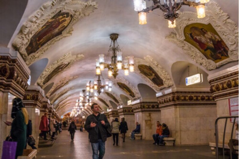 Tourists take in the stunning interiors of the Moscow Metro Station.