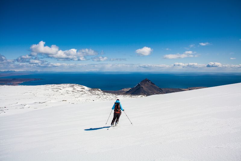 A skier looking at the view of Snaefellsjokull Peninsula