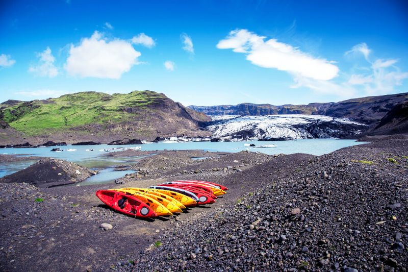 Breathtaking scenery with kayak boats in Sohlheimajokull.