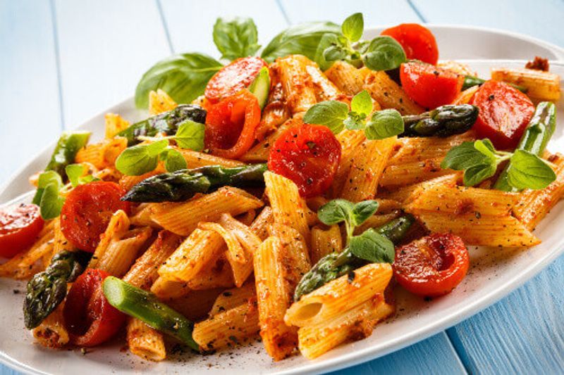 Penne pasta with meat, tomato sauce and vegetables