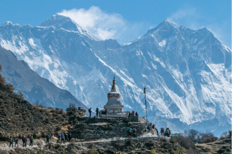 A quaint pagoda stands in the shadow of the immense Mount Everest.