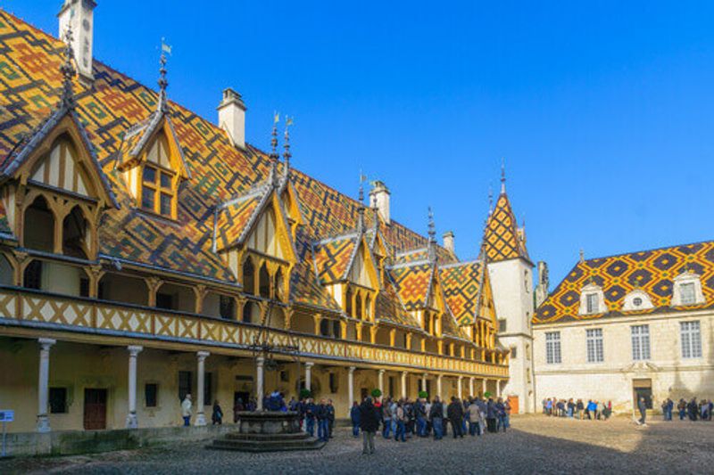The Hospices of Beaune with visitors arriving for the wine auction in Beaune, Burgundy.