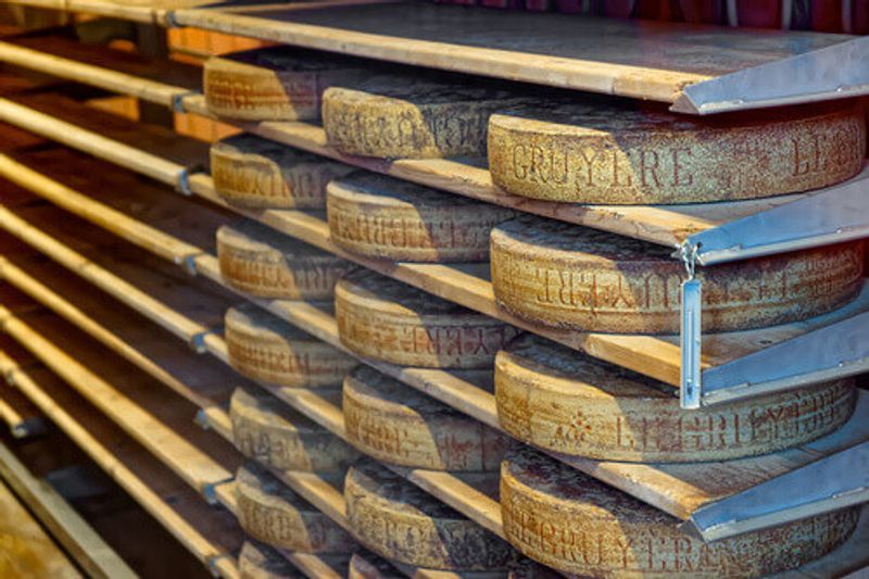 Aging cheese in a cellar of the Maison du Gruyere Cheese Factory in Switzerland.