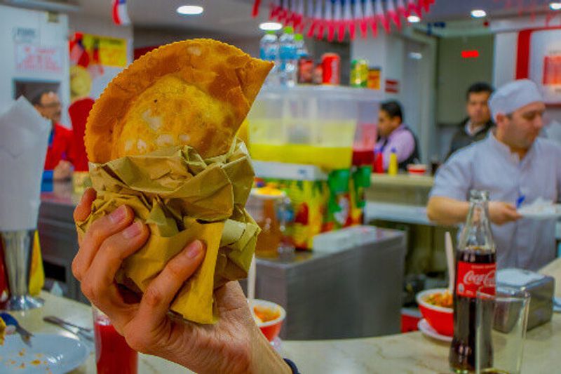 Close-up of Chilean Empanada, baked pastry stuffed with ham and cheese, in the El Rapido restaurant in Santiago, Chile.