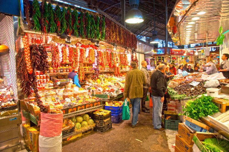 Tourists shop in the famous La Boqueria market in Barcelona, Spain.