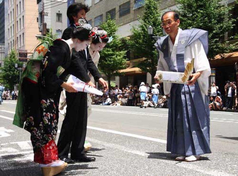 Two geishas bowing in Kyoto, Japan.