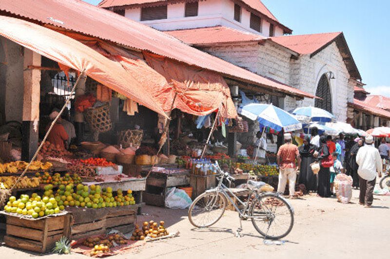 Locals and tourists at a local market selling organic fresh fruits.