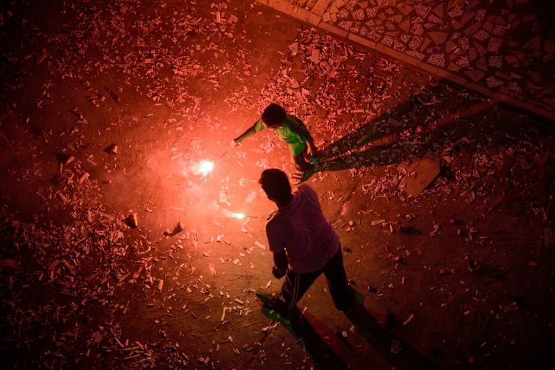 Father and son enjoying the fireworks celebrating Diwali