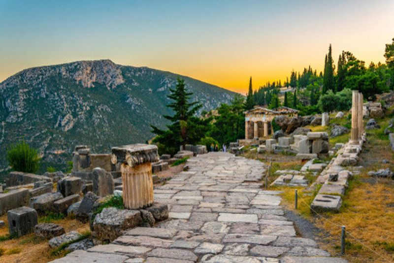 A landscape of the sunset at the Athenian Treasury in Delphi.
