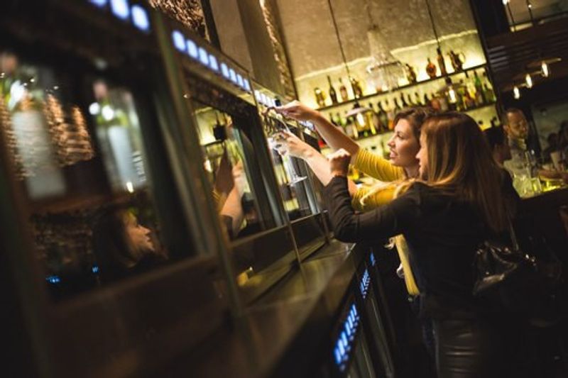 Women pouring wine in the Vico Wine Bar in Argentina.