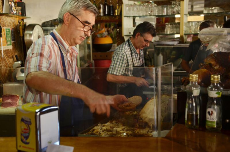 A local chef makes a tasty Bifana sandwich.