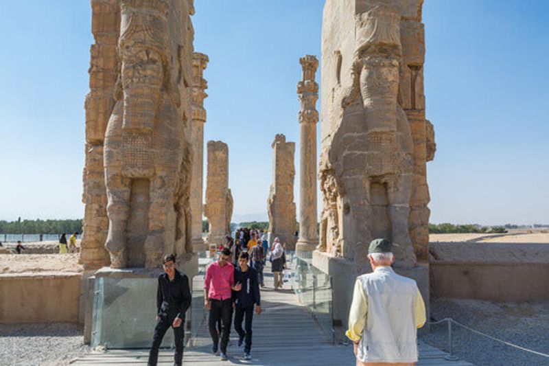 Tourists at the ruins of the Gate of All Nations in Persepolis.